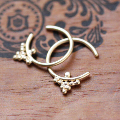 Yellow gold open hoop earrings with beaded cluster detailing.