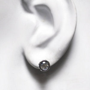 5mm round rainbow moonstone stud earrings in sterling silver with beading around the sides shown on the ear