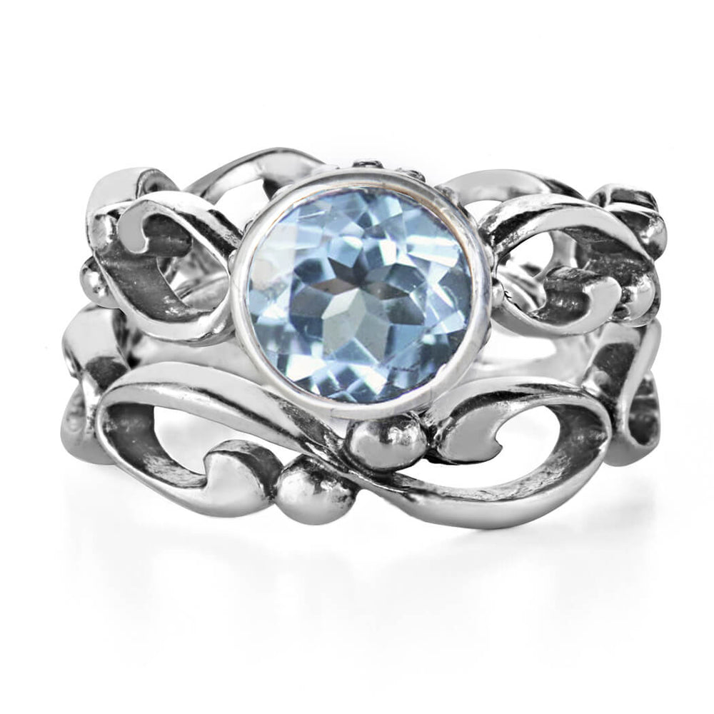 Aquamarine gemstones set in a sterling silver band that features infinity symbols. 