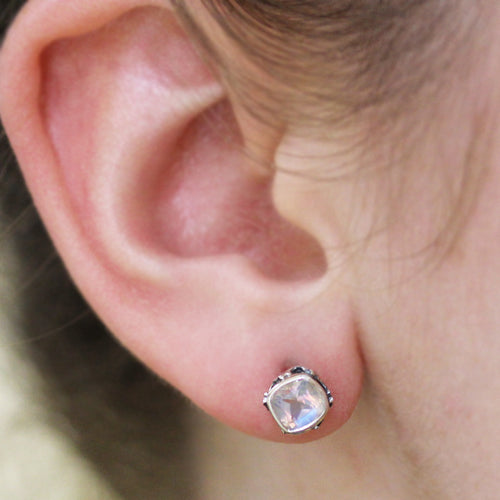 cushion shaped rainbow moonstone stud earrings on ear