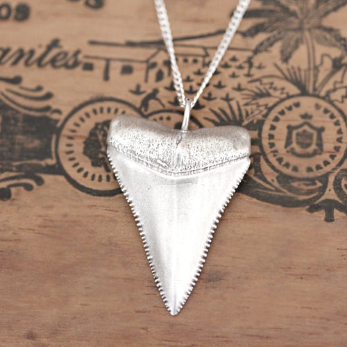 Centered close-up shot of the sterling silver great white shark tooth necklace from Metalicious