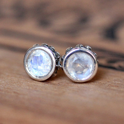 Front view of 5mm round rainbow moonstone stud earrings in sterling silver with beading around the sides