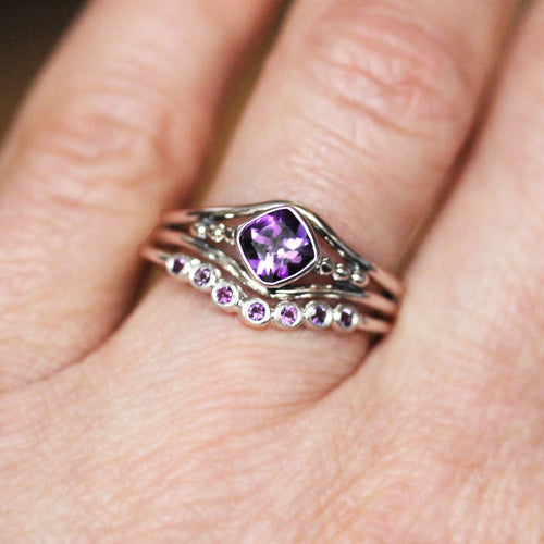 The handmade sterling silver ring set with amethyst from Metalicious being worn
