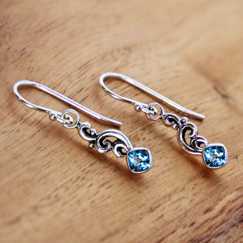 silver dangle earrings with bezel set square cushion blue topaz gems, and silver wave design